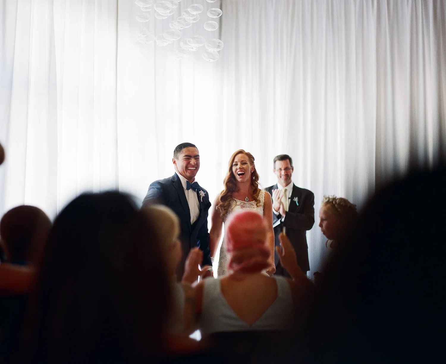 Small group of people standing together at an indoor gathering.