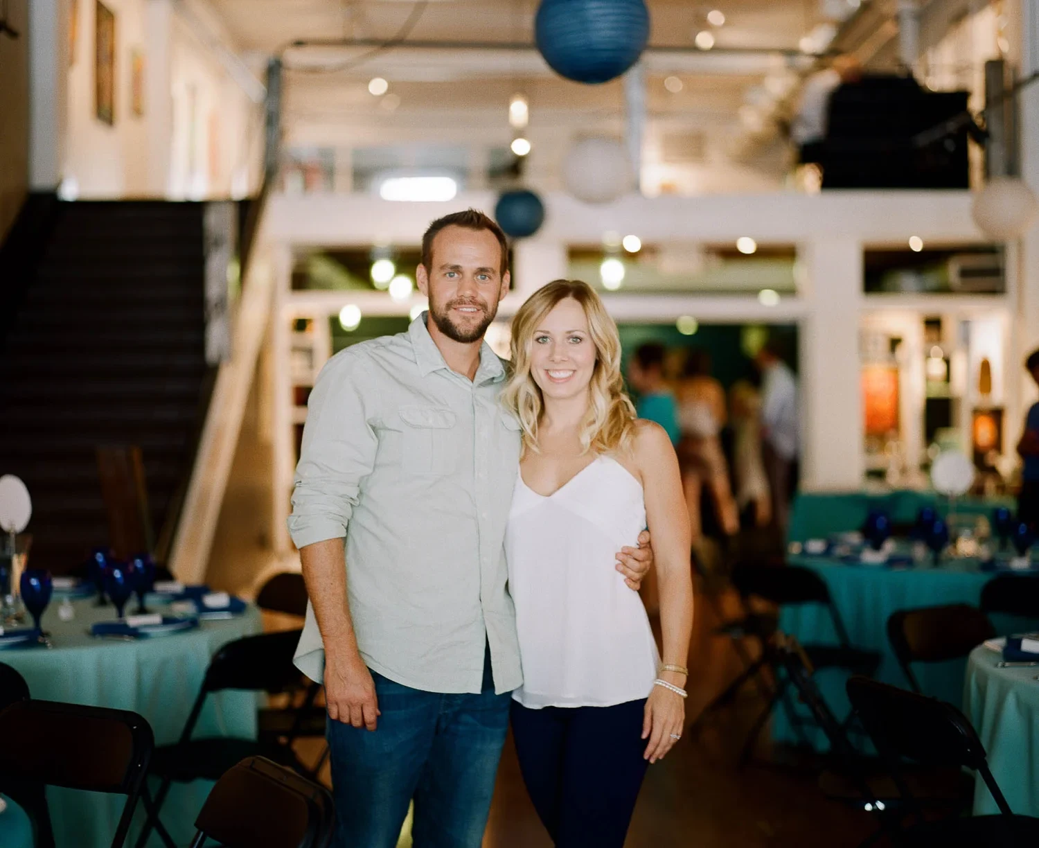 A smiling couple posing together inside a restaurant.
