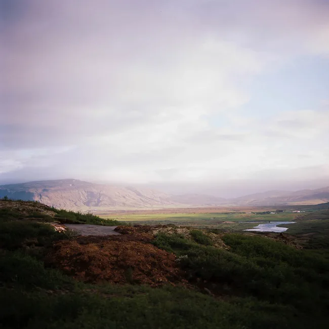 Soft, misty light over a broad Icelandic valley.