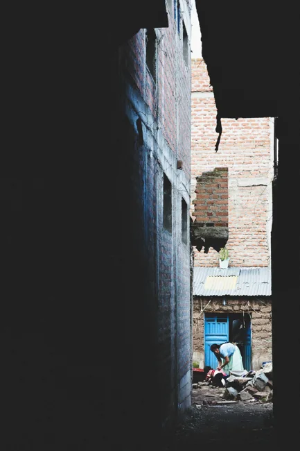 A sliver of bright daylight between closely spaced buildings.
