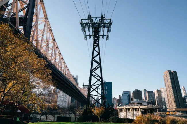 Suspension bridge spanning toward the New York skyline.
